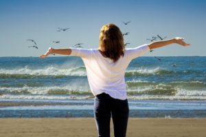 woman stretching at the beach