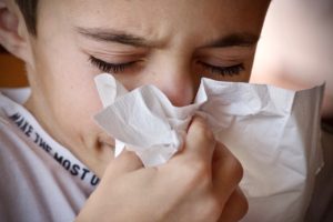 boy sneezing